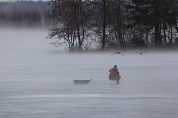 A person ice fishing.