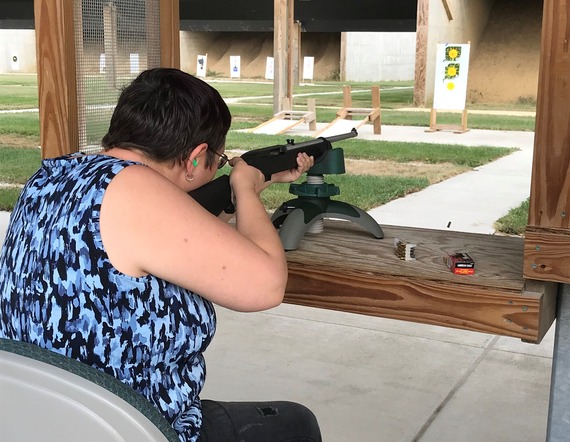 A woman shooting at a range.