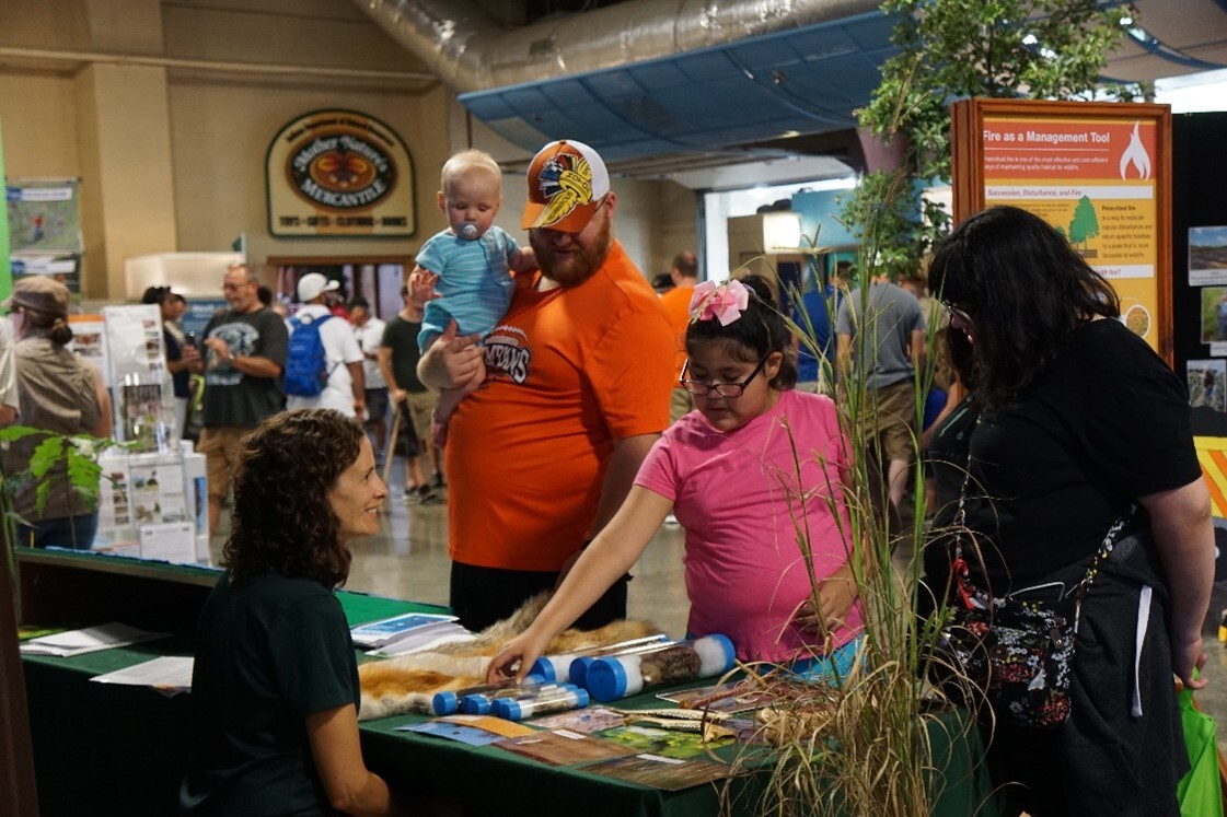 DNR staff with customers at the State Fair DNR Building.