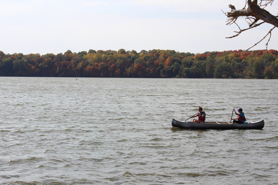 Two people paddling in a canoe.