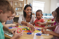 Woman in a classroom with young children