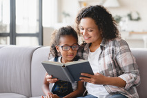 Mom and daughter reading a book 