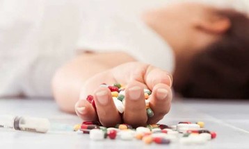 Youth holding pills