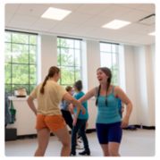 Two women dancing together during a clogging class