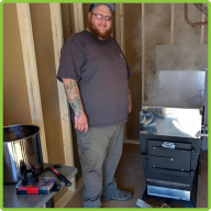 Naturalist Kyle standing in the Sugar Shack, boiling sap for maple syrup