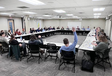 Image of a group of people around a large table