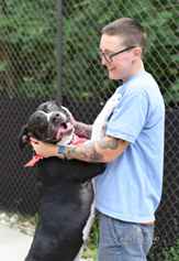 Animal Shelter Volunteer with Dog
