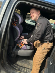 image of Deputy putting in car seat