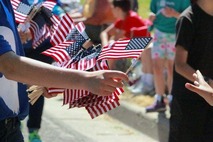 Image of person handing out american flags