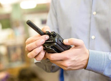 Image of a man holding a school radio