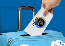 Image of a person putting a vote card into a suitcase