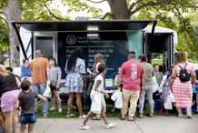 Image of people at National Night Out, in front of the Health Department mobile unit