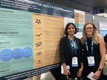 Image of two women by their poster board health abstracts