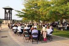 Image of the Somethings Grilling fundrasing event, with people mingling outside