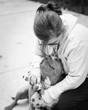 Image of a woman cuddling a dog