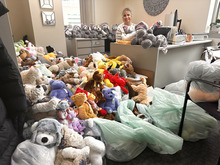 Image of a woman in an office, surrounded by donated stuffed animals