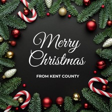 Image of "Merry Christmas from Kent County," with pine around image