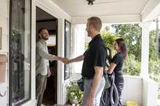 Image of cleaners greeting a resident at the door