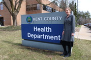 Dr. Kristin Oldenberg poses near the Kent County Health Department sign.