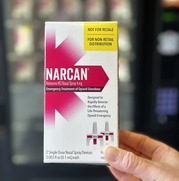 Person holding a box of Narcan