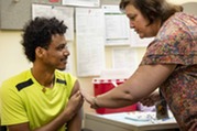 Public Health Nurse Provides an Immunization to a Client