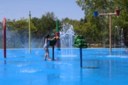 Young Girl Playing at Millennium Park's Splashpad on a Sunny Day