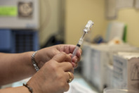 Pictured is KCHD employee prepping a syringe ahead of an appointment.