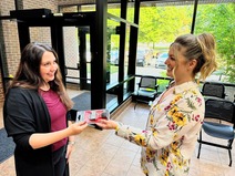 Pictured is a KCHD employee handing a free firearm lock to a community member.