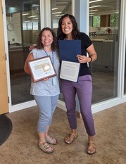 Immunization Program Supervisor, Amy Shears, accepting the People's Champion Award for July from Emergency Preparedness Coordinator Mindy Hunsinger.