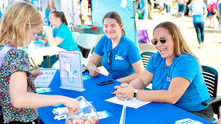 Image of a woman talking to a child at Community Fest
