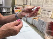 Nurse Prepares a Vaccine Ahead of an Appointment