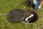 Kent County Health Department Sanitarian Inspecting a Homeowner's Well and Septic System