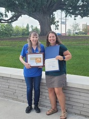 The Recipient of July's People's Champion Award, Amy Shears, Poses Next to Her Selection for August, Christine Stewart
