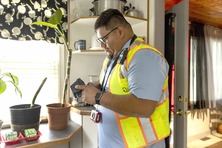 Image of a man with a meter reader in a home