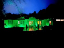 Image of a home lit up in green light
