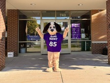 Image of a dog mascot, wearing its new name "Bark Kent" on a t-shirt