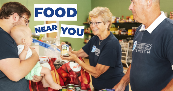 Volunteers with Flat River Outreach Ministries Hand Food to a Father and Baby