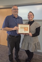 October's People's Champion Award Recipient Greg VanderKooi Posing Next to the November Recipient, Sophie Gwasdacus