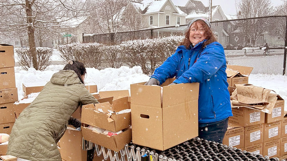 Image of a wo,an working on food distribution in the winter