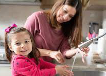 mother and daughter at the sink