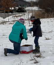 A Mother and Son Spread Native Seeds Across a Kent County Park on a Snowy, Winter Day