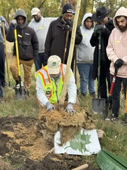 A Diverse Group of People with Steepletown Neighborhood Services Plant Trees along Kent Trails North Trailhead on a Cloudy, Fall Day