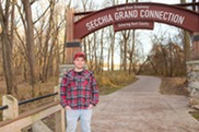 Avid Park-Goer Nick Meekhof Poses for a Picture in Front of the Grand Secchia Archway Near Jenison