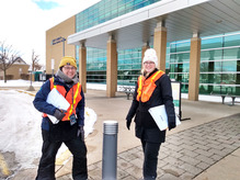 Two staff ready for food distribution