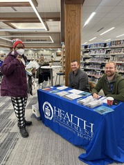 Kent County Health Department staff host a table at the Kent District Library's Grandville location to hand out free radon test kits this January 2026