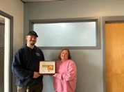 Last month's People's Champion Award recipient hands off the award to this month's winner, Marlene Kroft