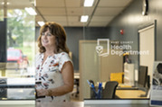 Kent County Health Department employee ready to greet customers at the intake desk