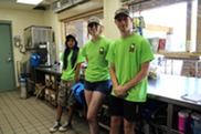 Three Young Seasonal Staffers Pose within Millennium Beach's Concession Stand