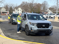 Volunteers checking in people for food distribution