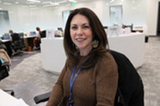 Kent County Health Department employee smiles as she sits at her desk within the North Clinic